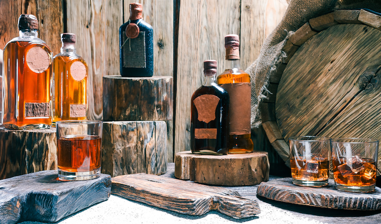 Australian whiskey bottles and glasses full of whisky on wooden boards
