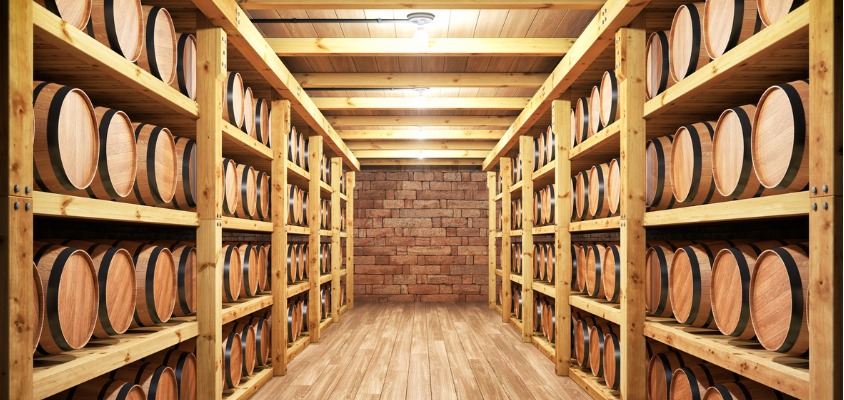 Barrels in a cellar full of Michael Courvreur whisky