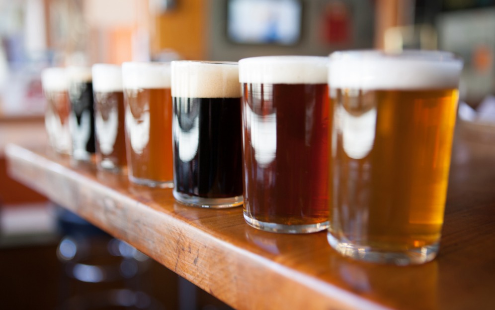 A row of different craft beer in glasses